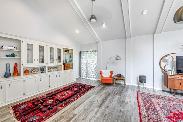 sitting room with light wood-style floors, lofted ceiling with beams, baseboards, and recessed lighting