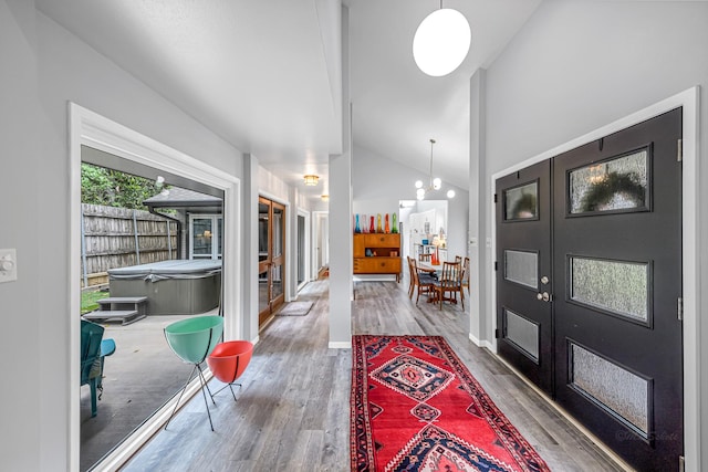 entryway with french doors, vaulted ceiling, and wood finished floors
