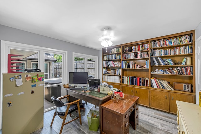 office space with ceiling fan and light wood finished floors