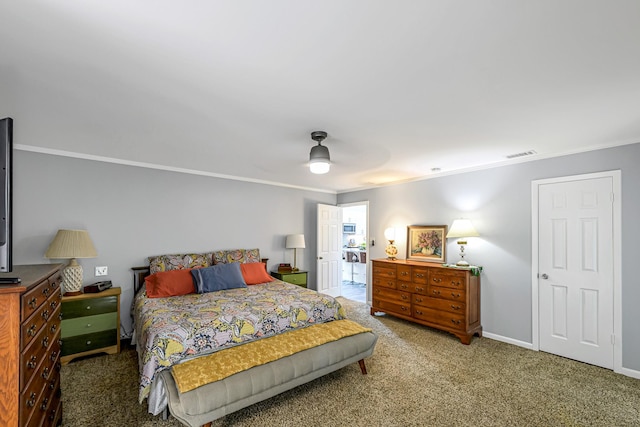 carpeted bedroom with visible vents, baseboards, crown molding, and ceiling fan