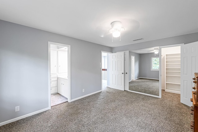 unfurnished bedroom with baseboards, carpet flooring, and visible vents