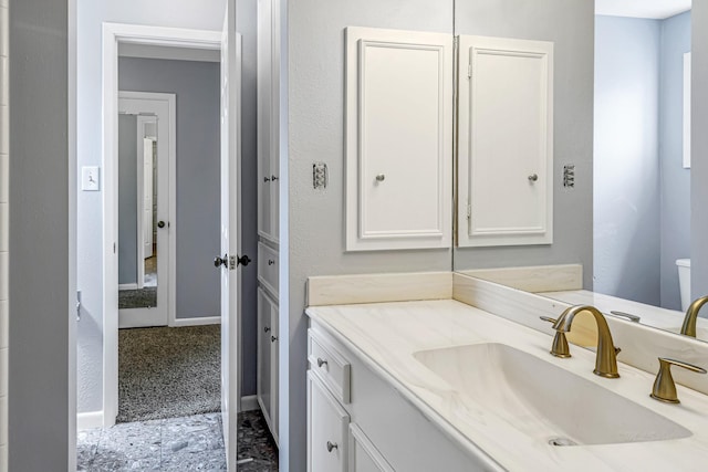 bathroom with vanity and baseboards