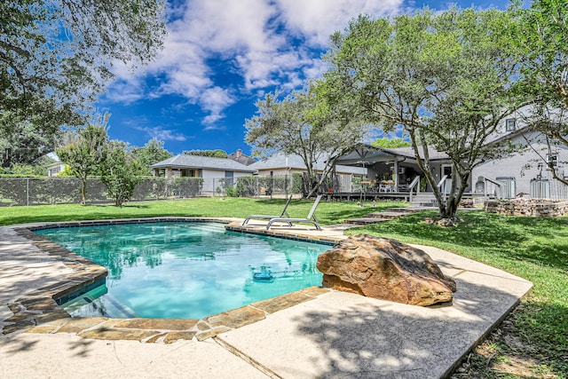 view of pool with fence, a fenced in pool, and a lawn