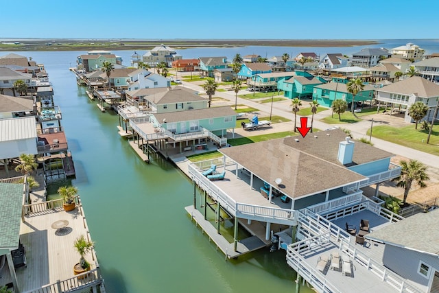 bird's eye view featuring a water view and a residential view