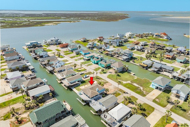 drone / aerial view with a water view and a residential view