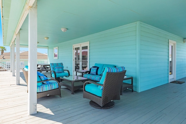 wooden terrace with french doors and an outdoor hangout area