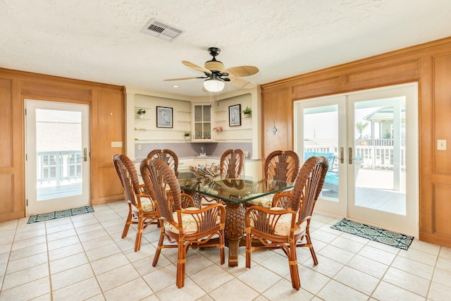dining space featuring light tile patterned floors, french doors, visible vents, and a healthy amount of sunlight