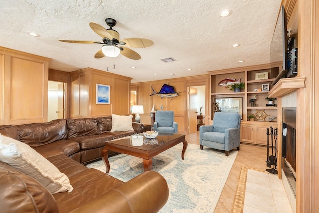 living area with light tile patterned floors, visible vents, ceiling fan, a textured ceiling, and recessed lighting