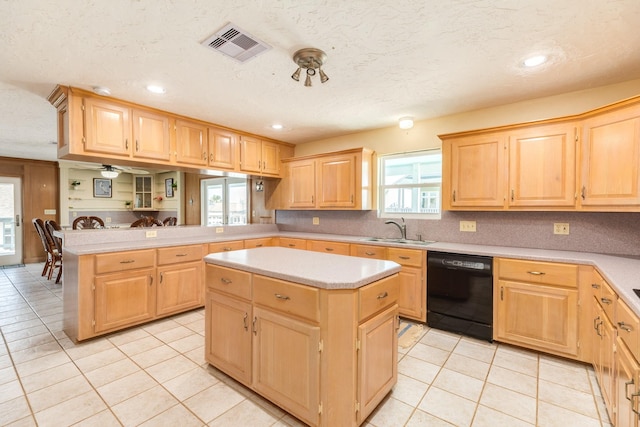 kitchen with light tile patterned floors, a peninsula, black dishwasher, a sink, and light brown cabinets