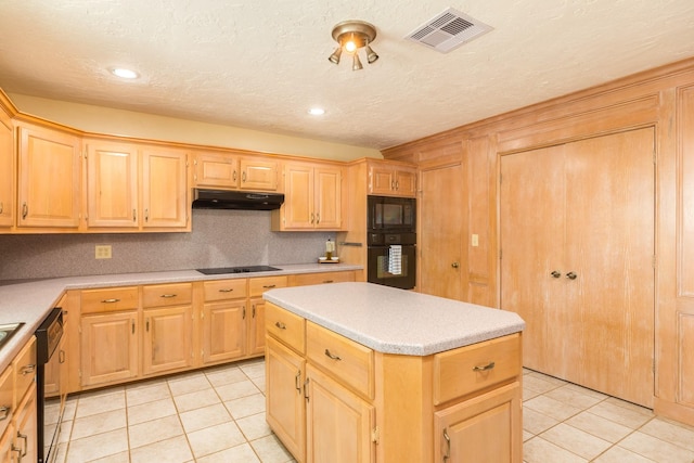 kitchen with visible vents, light tile patterned floors, light brown cabinets, under cabinet range hood, and black appliances