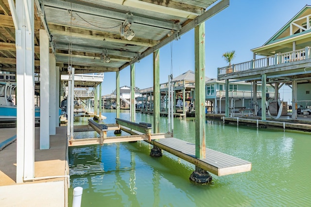 dock area featuring boat lift and a water view