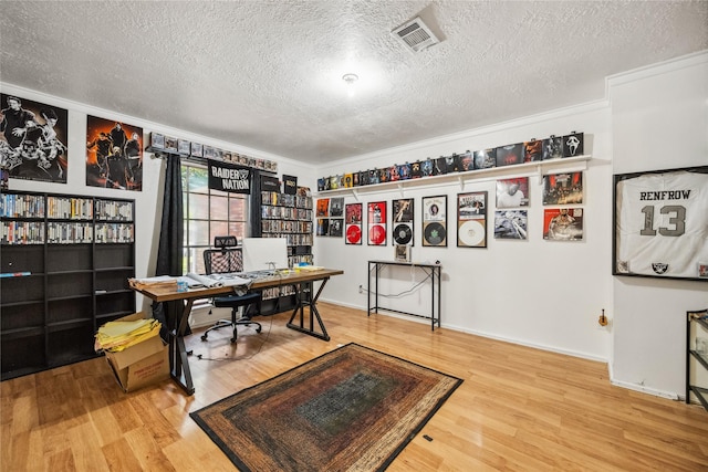 office space with visible vents, wood finished floors, and a textured ceiling