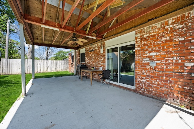 view of patio with ceiling fan and fence