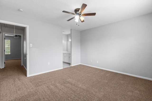 unfurnished bedroom with baseboards, carpet, and attic access
