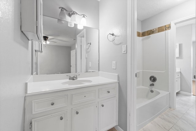 full bath featuring shower / bath combination, vanity, a ceiling fan, and a textured ceiling