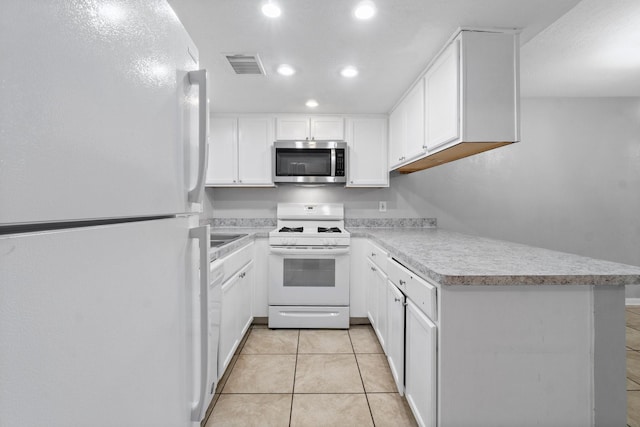kitchen featuring visible vents, white cabinetry, light countertops, recessed lighting, and white appliances