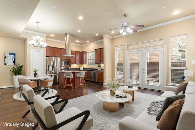 living room with crown molding, dark wood-style floors, french doors, and ceiling fan with notable chandelier
