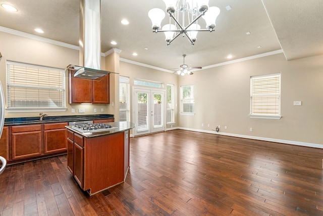 kitchen with dark countertops, stainless steel gas cooktop, island range hood, open floor plan, and recessed lighting