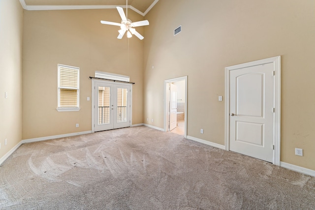 spare room featuring french doors, carpet flooring, visible vents, a ceiling fan, and ornamental molding
