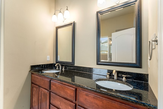 bathroom with a sink and double vanity