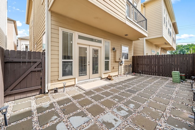 view of patio featuring a gate, french doors, and fence