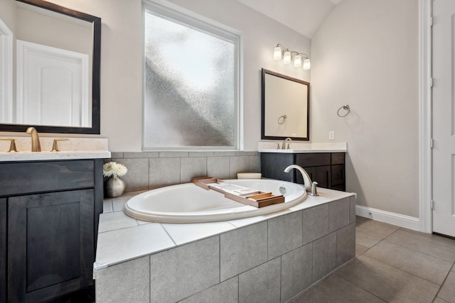 4290 Orchard Pass Dr, Spring, TX 77386 - bathroom with a bath, two vanities, tile patterned flooring, vaulted ceiling, and baseboards