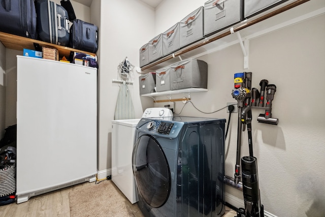 4290 Orchard Pass Dr, Spring, TX 77386 - clothes washing area featuring washer and clothes dryer, wood finished floors, and baseboards