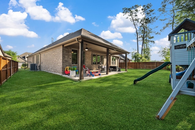 4290 Orchard Pass Dr, Spring, TX 77386 - back of property with central air condition unit, a playground, brick siding, ceiling fan, and a patio