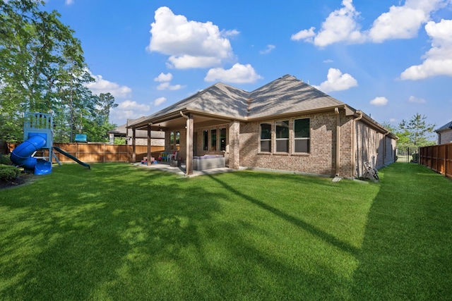 4290 Orchard Pass Dr, Spring, TX 77386 - rear view of property featuring a patio area, brick siding, and a playground