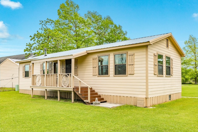 manufactured / mobile home with a front yard and metal roof