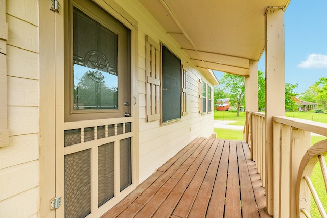 wooden terrace featuring covered porch