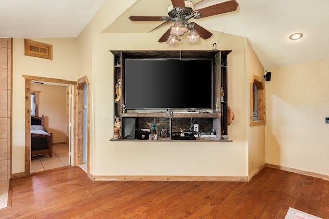room details with wood finished floors, visible vents, a ceiling fan, and baseboards