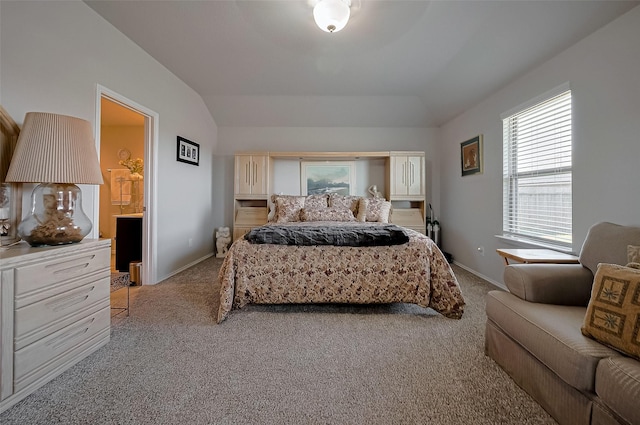 bedroom with carpet floors, baseboards, and lofted ceiling