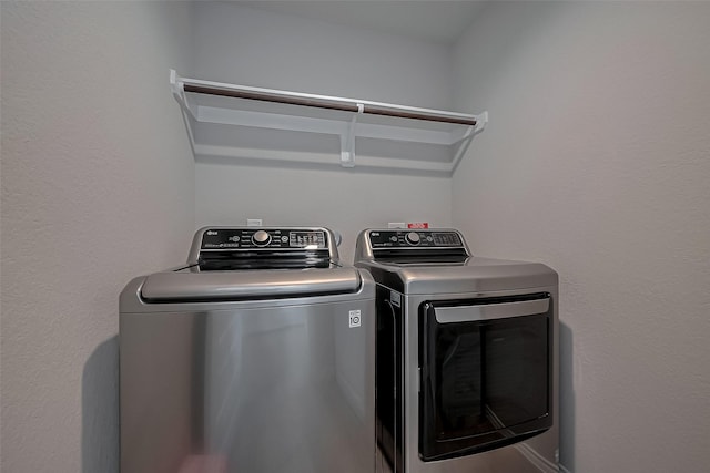 washroom with separate washer and dryer and laundry area