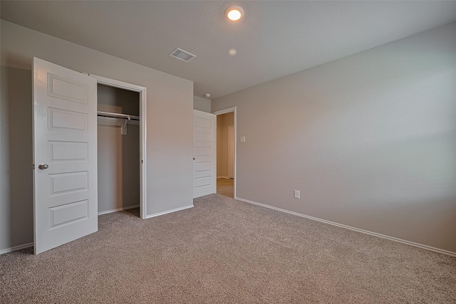 unfurnished bedroom featuring a closet, baseboards, carpet, and visible vents