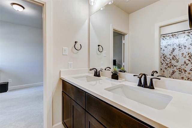 7606 Redwoods Forest Dr, Katy, TX 77493 - bathroom featuring double vanity, a sink, and baseboards