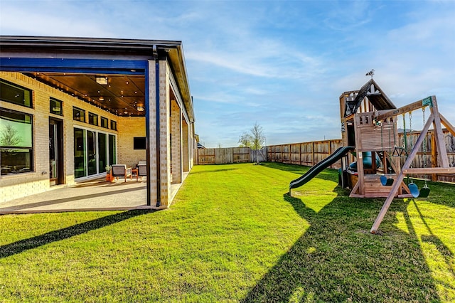 7606 Redwoods Forest Dr, Katy, TX 77493 - view of yard with a patio, a fenced backyard, and a playground