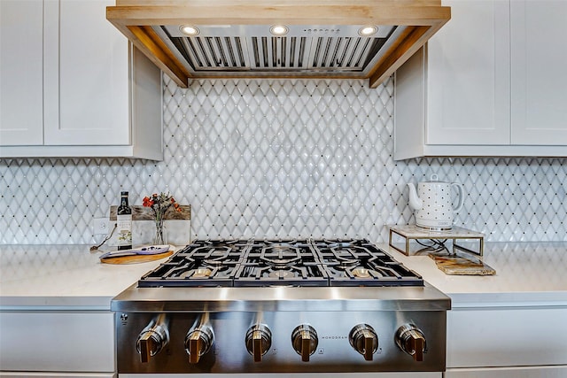 7606 Redwoods Forest Dr, Katy, TX 77493 - kitchen with tasteful backsplash, wall chimney range hood, recessed lighting, white cabinetry, and stainless steel gas cooktop