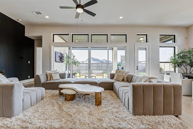 7606 Redwoods Forest Dr, Katy, TX 77493 - living area featuring wood finished floors, ceiling fan, visible vents, and recessed lighting