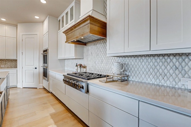 7606 Redwoods Forest Dr, Katy, TX 77493 - kitchen featuring white cabinets, light countertops, recessed lighting, stainless steel appliances, and backsplash