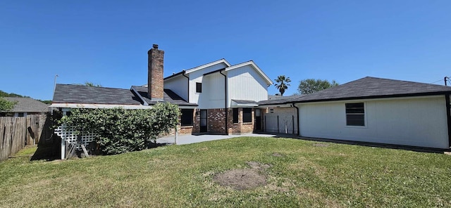 47 W Dansby Dr, Galveston, TX 77551 - rear view of house featuring a lawn, a patio area, fence, brick siding, and a chimney