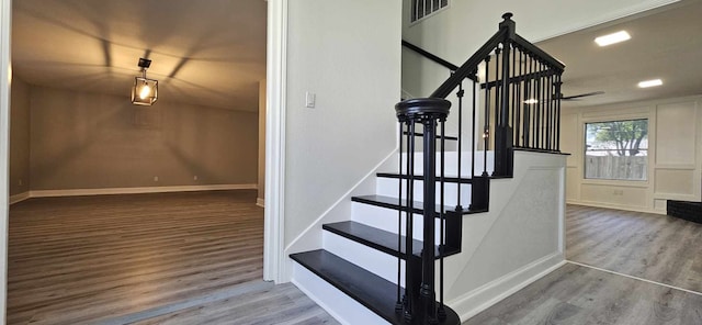 47 W Dansby Dr, Galveston, TX 77551 - staircase with visible vents, baseboards, and wood finished floors