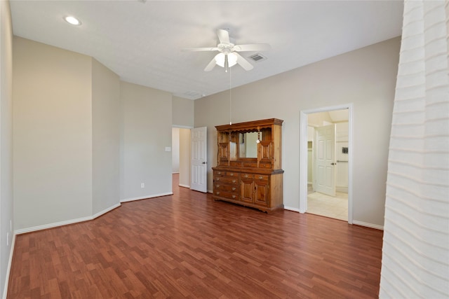 unfurnished bedroom featuring visible vents, baseboards, and wood finished floors