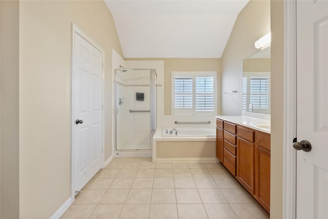 bathroom with a shower stall, a garden tub, vanity, tile patterned floors, and lofted ceiling
