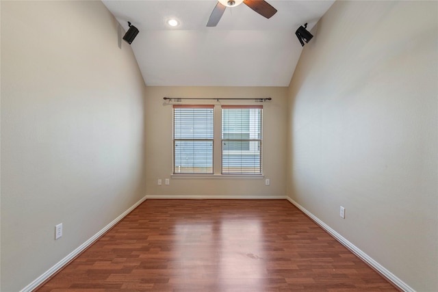spare room with baseboards, vaulted ceiling, wood finished floors, and ceiling fan