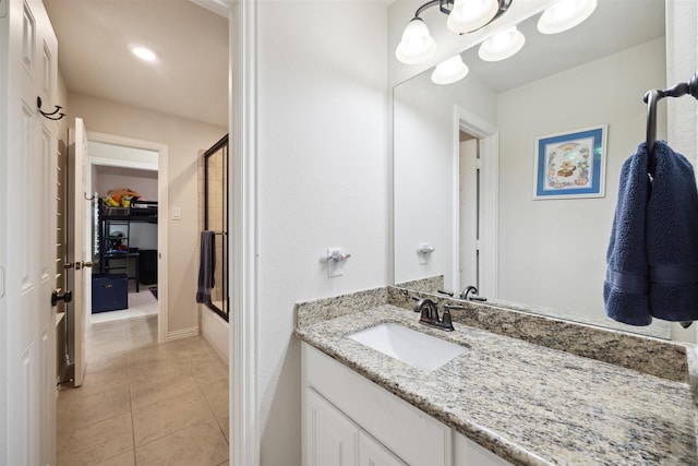 full bathroom with shower / bath combination with glass door, vanity, baseboards, and tile patterned flooring
