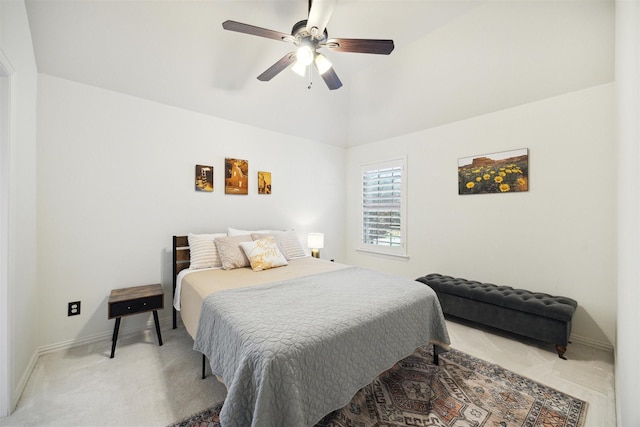 bedroom featuring light carpet, ceiling fan, baseboards, and vaulted ceiling