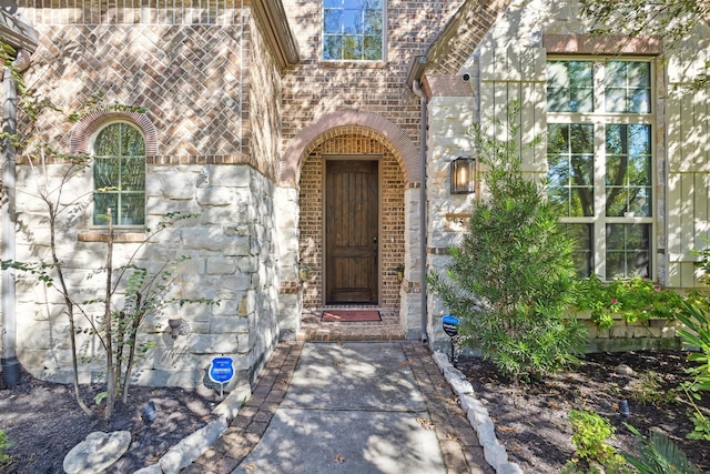entrance to property featuring brick siding