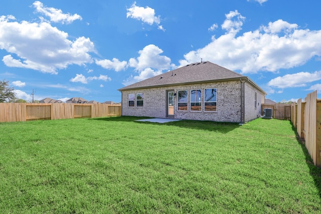 1613 Mija Park Rd, Seabrook, TX 77586 - rear view of property featuring a yard, a fenced backyard, roof with shingles, brick siding, and central AC unit