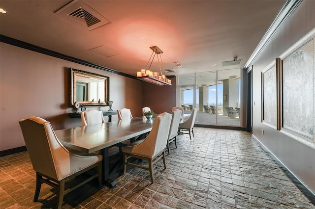 dining area featuring visible vents, ornamental molding, stone tile flooring, baseboards, and a notable chandelier